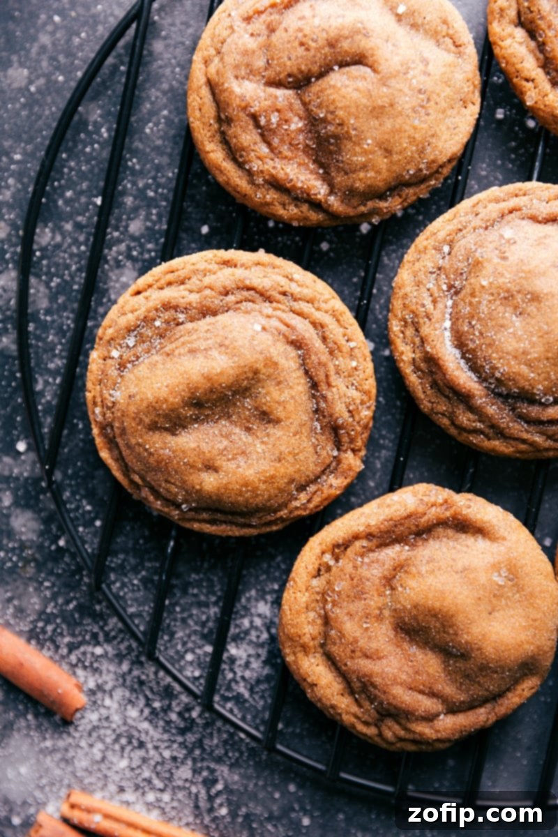 Freshly baked Gingersnap Cookies cooling on a wire rack.