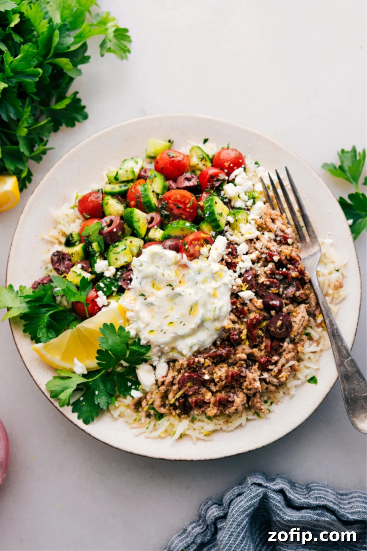 Greek Ground Turkey Bowls: Your New Favorite Meal Delicious Greek Ground Turkey bowls, featuring seasoned turkey, lemon-parsley rice, fresh vegetables, and tzatziki drizzle.