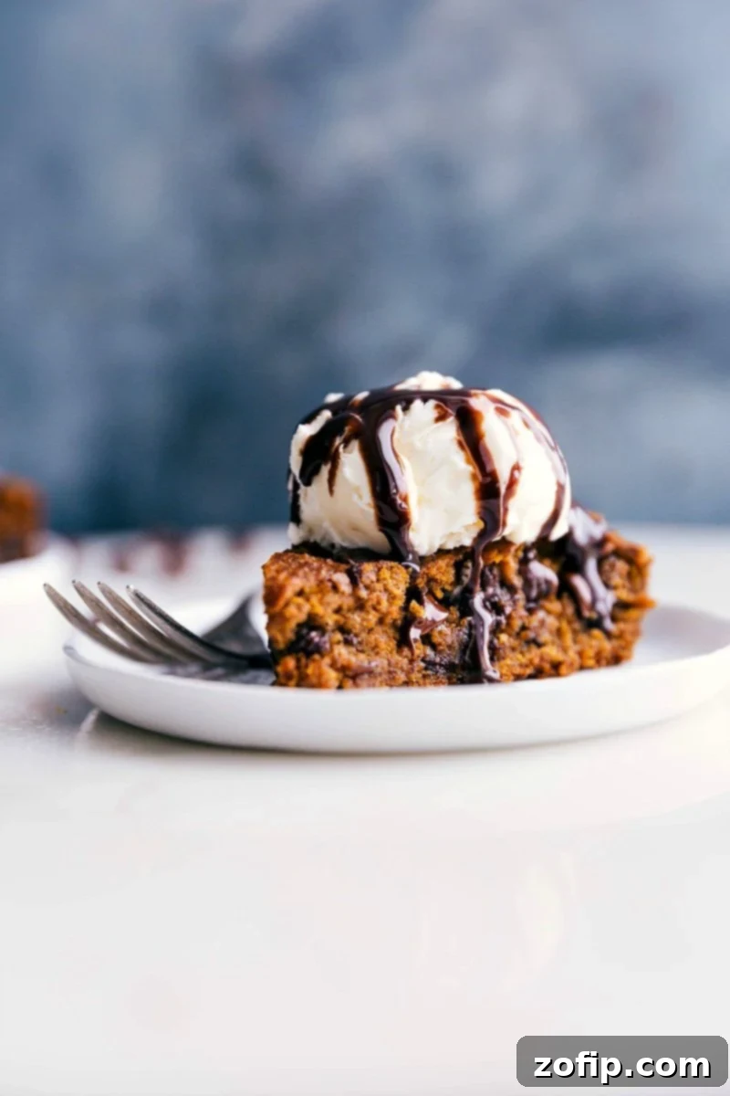 Delectable Gluten-Free Pumpkin Cake with Ice Cream, Ready to Savor Gluten-free pumpkin cake on a plate, crowned with a scoop of ice cream, prepared for a delicious treat.