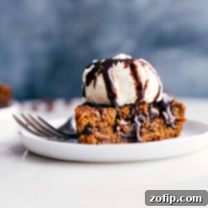 Gluten-Free Pumpkin Spice Delight 3 Gluten-free pumpkin cake on a plate, crowned with a scoop of ice cream, prepared for a delicious treat.