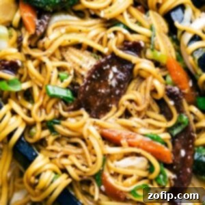 Finished Beef Chow Mein with tongs holding the noodles, a perfect weeknight meal.