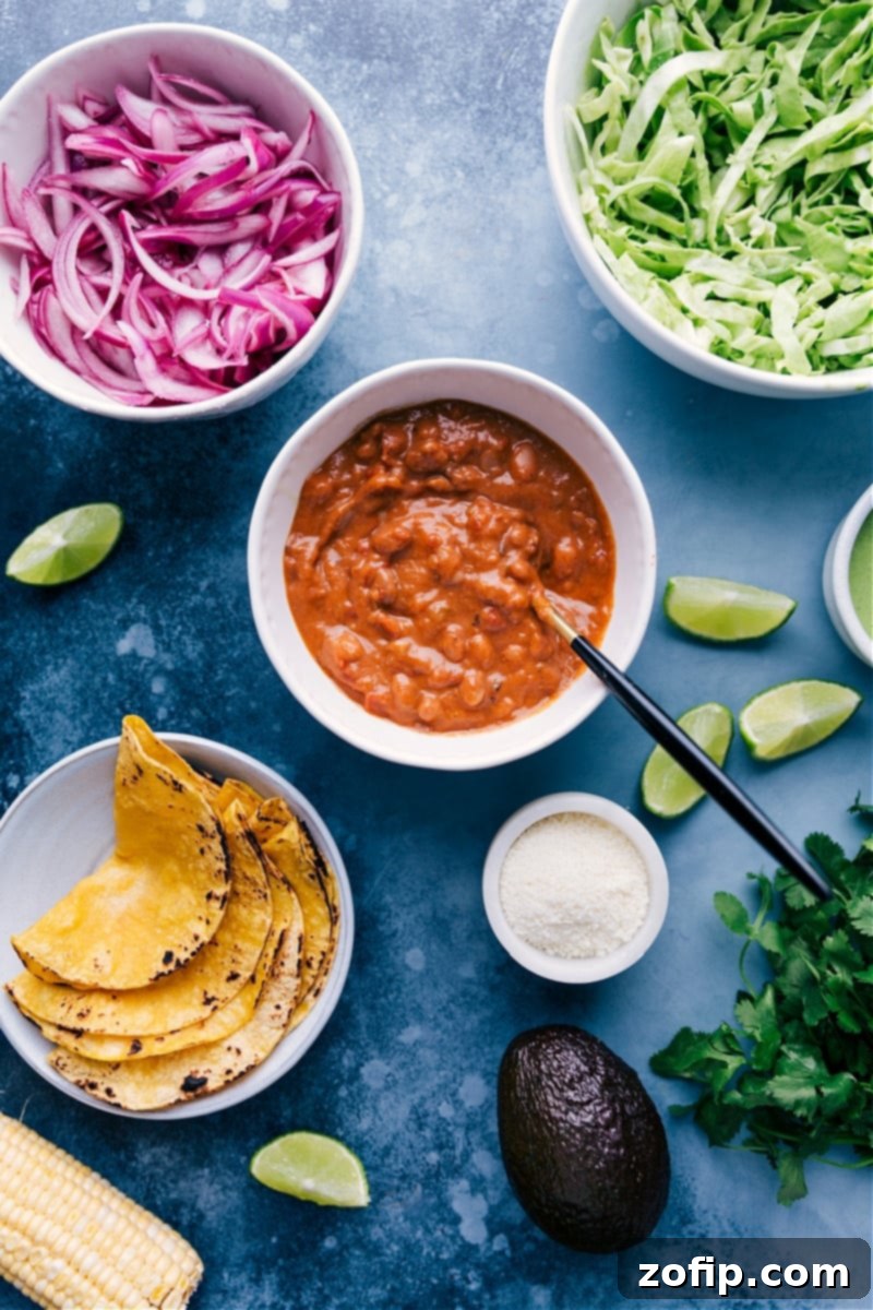 The freshest ingredients come together for these nutritious and filling Pinto Bean Tacos: saucy pinto beans, cilantro-lime slaw, crisp corn, and quick pickled red onions. A step-by-step collage showing the vibrant individual components of Pinto Bean Tacos: fresh corn kernels, shredded cabbage, a bowl of saucy pinto beans, and bright quick-pickled red onions.