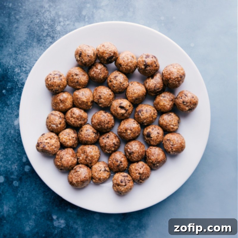 Wholesome Oatmeal Bites 4 A close-up view of a pristine white plate generously filled with perfectly shaped Oatmeal Energy Balls, ready to be enjoyed.