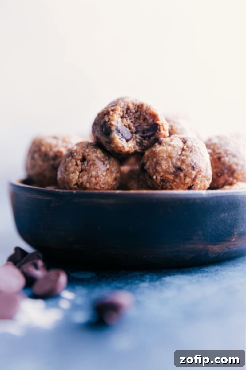 Wholesome Oatmeal Bites 5 A vibrant bowl of Oatmeal Energy Balls, showcasing their appealing golden-brown hue and varied textures. These delicious, pop-able bites truly taste like healthy oatmeal chocolate chip cookies, making them a perfect guilt-free indulgence.