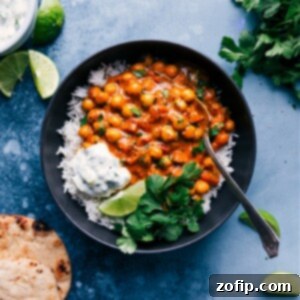 A delicious bowl of homemade Chickpea Curry, served with rice and cilantro garnish.