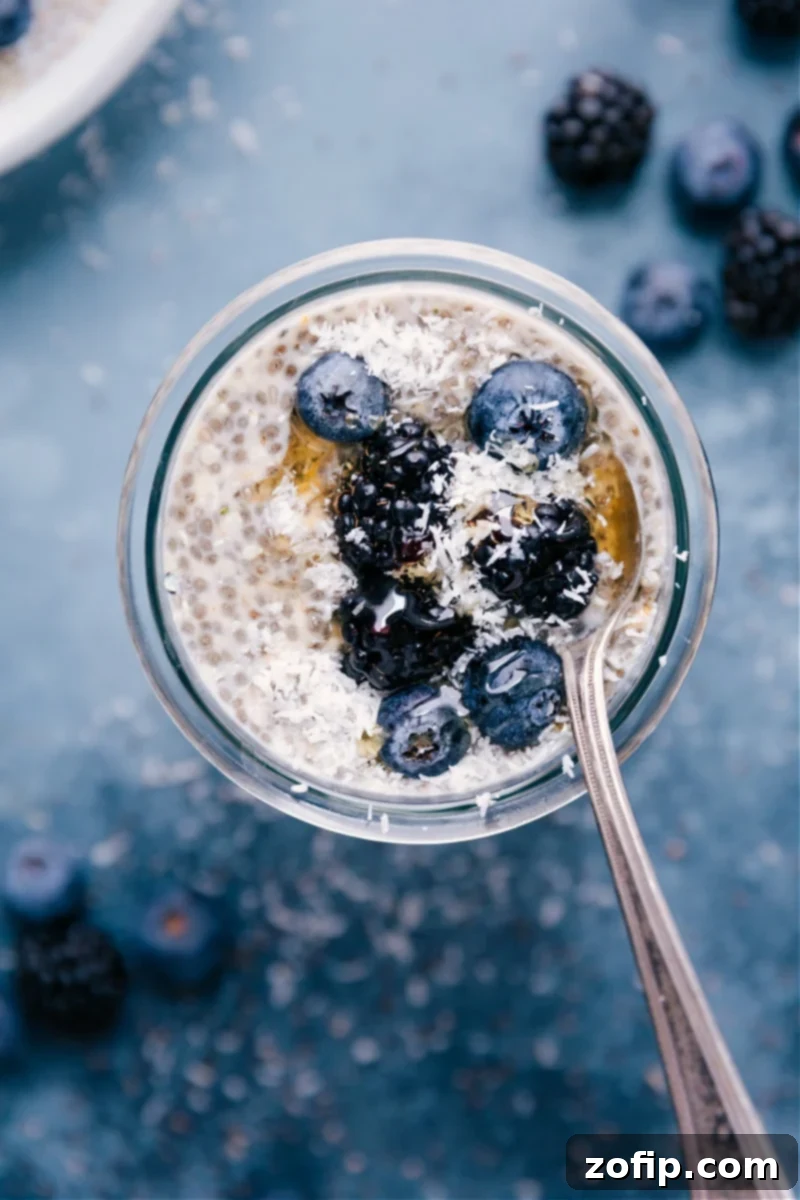 The Best Chia Seed Pudding: Perfectly Sweetened with Citrus & Vanilla, topped with fresh fruit and coconut. Overhead image of a delightful Chia Seed Pudding in a cup, ready to be enjoyed.