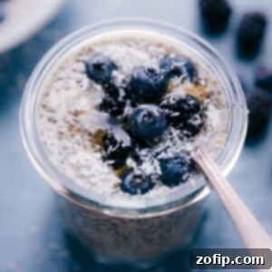 Overnight Chia Goodness 2 A serving of Chia Seed Pudding with berries on top in a glass jar.