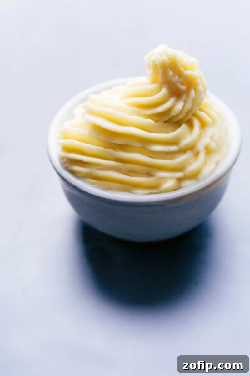 A vibrant bowl of homemade copycat Dole Whip, featuring its signature creamy, soft-serve texture and a hint of tropical paradise, ready to be enjoyed as a refreshing sweet treat.