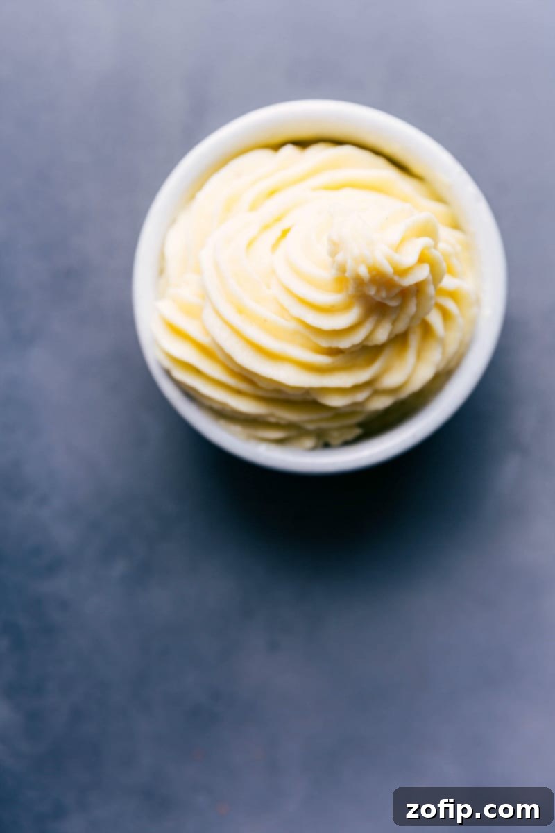 A delicious bowl of homemade Dole Whip, showcasing its characteristic fluffy and sweet soft-serve consistency, inviting a satisfying spoonful.