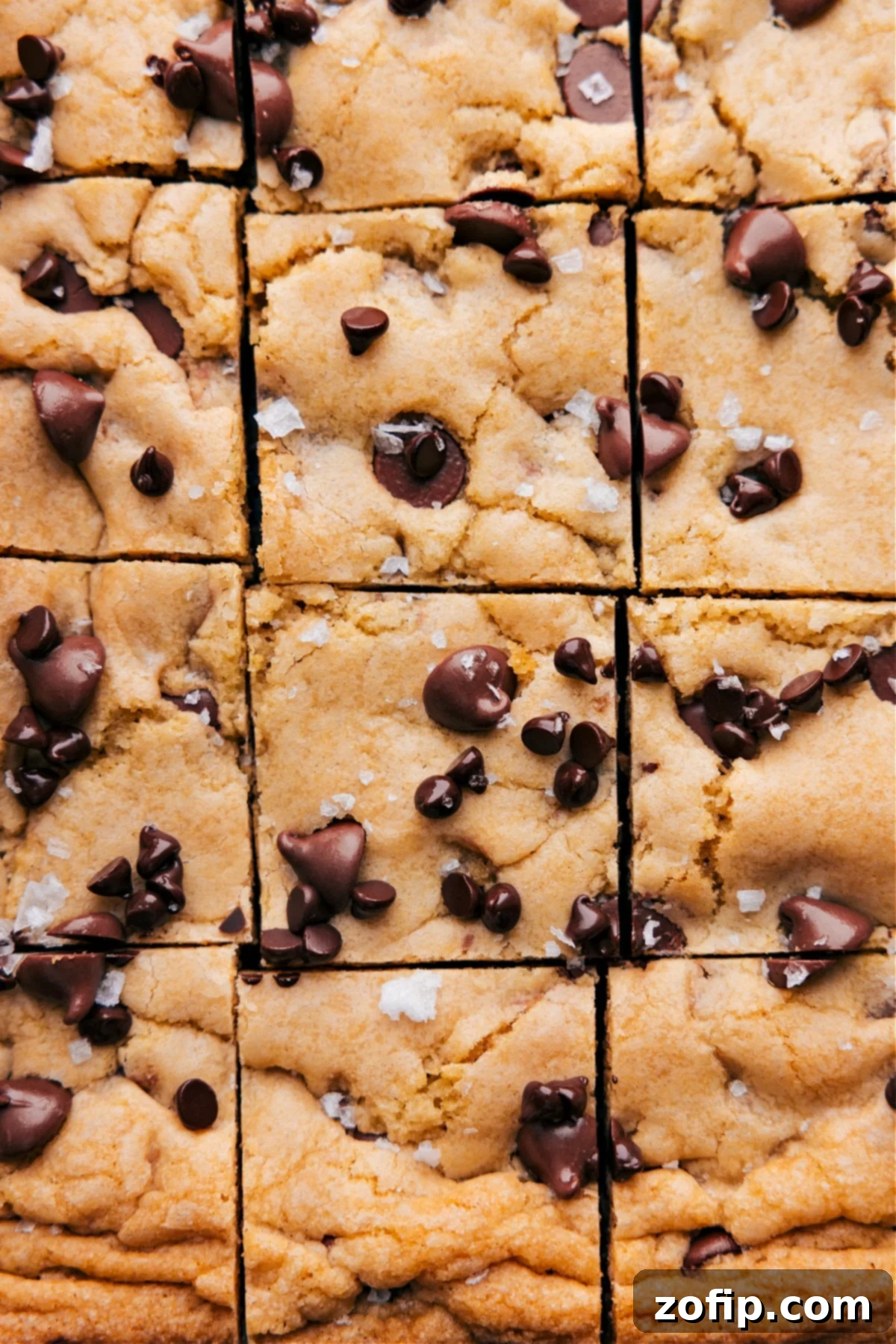 Perfectly cut Chocolate Chip Cookie Bars arranged in neat squares, showcasing their golden-brown edges and gooey chocolate chips.