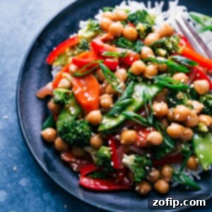 A serving of General Tso Chickpeas with rice in a bowl.