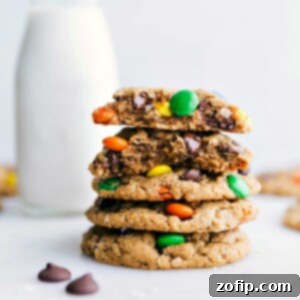 Healthy Monster Cookies stacked on top of each other with one broken in half showing off the middle, highlighting the soft, chewy interior.