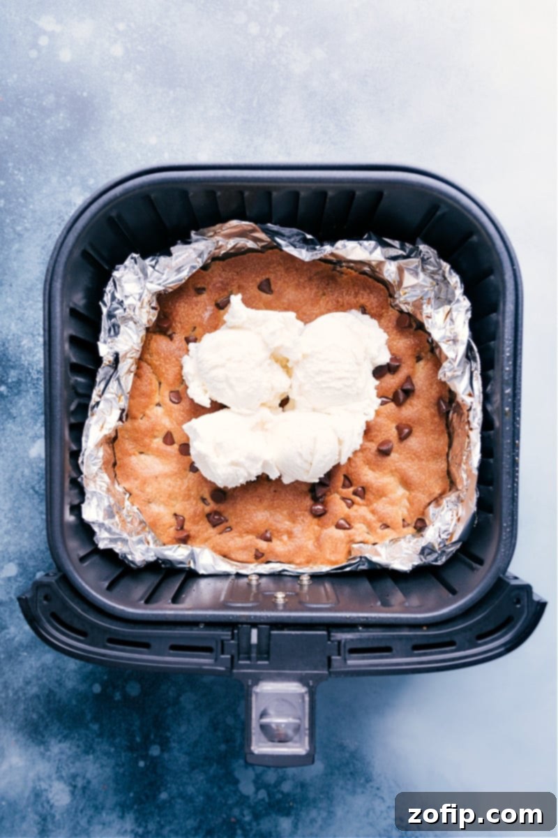 Air Fryer Pizookie: Quick, Gooey, and Perfect Delicious Air Fryer Pizookie topped with vanilla ice cream and chocolate drizzle, ready to be served.