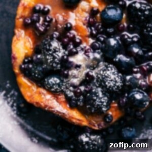 Air Fryer Dutch Baby Perfection 2 Fluffy Air Fryer Dutch Baby pancake with golden crust and fresh berries, close-up.