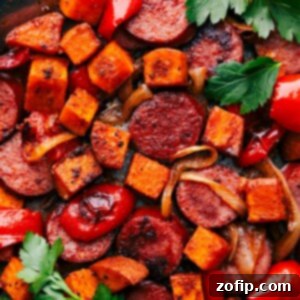 Sweet Potato and Sausage all on one pan fresh out of the oven, garnished with fresh herbs.