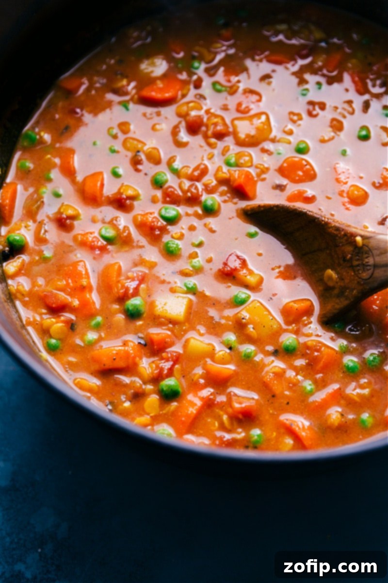 A close-up of the delicious Curry Lentil Soup, highlighting its rich textures and inviting colors for a perfect, healthy meal. A close-up of a single bowl of Curry Lentil Soup, showcasing its creamy texture, visible lentils, and colorful vegetable bits, ready to be enjoyed.