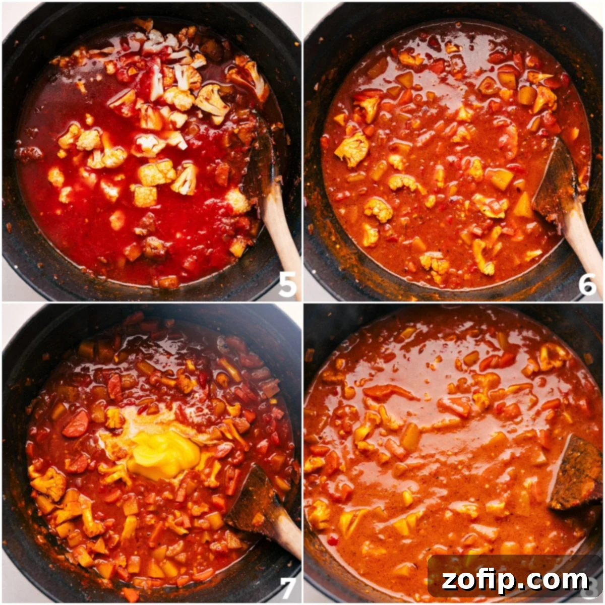 Rich crushed tomatoes and savory vegetable broth simmering together in a large cast-iron pot, creating the base for the flavorful Vegetable Masala.