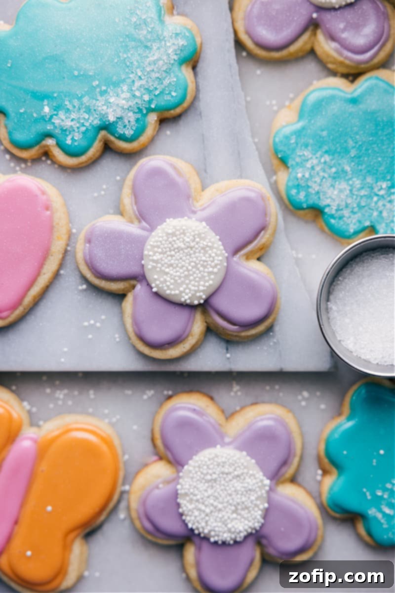 Our favorite Cut-Out Sugar Cookie Recipe: simple, delicious, and perfectly decorated cookies with easy icing and minimal chill time. Overhead image of beautifully decorated Cut-Out Sugar Cookies arranged on a platter, ready to be enjoyed.