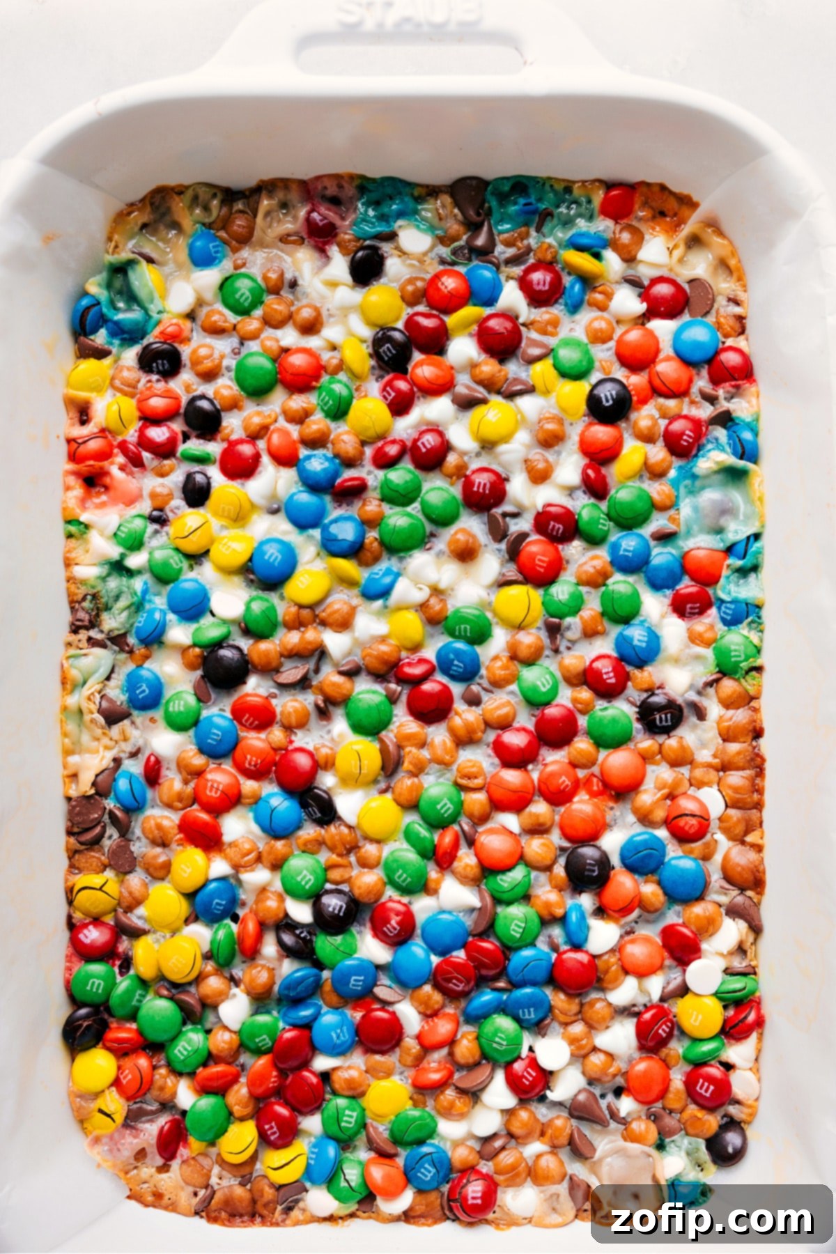 Warm, freshly baked Magic Cookie Bars with a golden-brown crust and melted, gooey toppings, cooling in the pan.