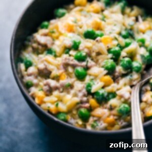 Easy 30 Minute One Pot Creamy Pesto Orzo 2 Creamy Pesto Orzo in a serving bowl with fresh basil garnish