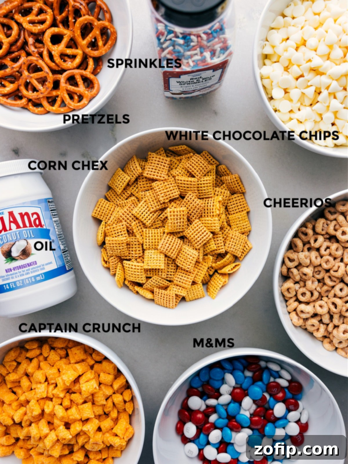 Ingredients For 4th Of July Snack Mix All the essential ingredients for the 4th of July Snack Mix, meticulously prepped and laid out for easy assembly, including cereals, pretzels, M&M's, and white chocolate chips.