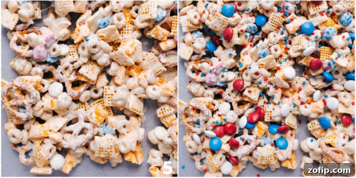 Assembling The Best 4th Of July Snack Mix Recipe The 4th of July snack mix spread evenly on a parchment-lined tray, with festive sprinkles being added on top before the white chocolate hardens completely.