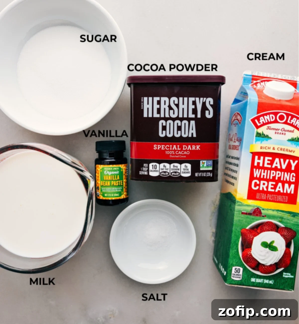 Ingredients laid out for this recipe, featuring cream, cocoa powder, sugar, and other essentials.