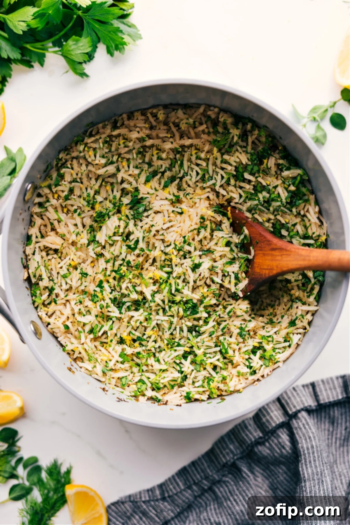 Greek Rice Recipe in a pot, showcasing fresh lemon zest and parsley.
