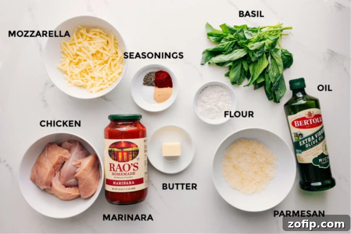 Ingredients In Parmesan Chicken Recipe Ingredients in this recipe prepped out for easy assembly including the mozzarella, chicken, seasoning, marinara, butter, flour, parmesan, basil, and oil.