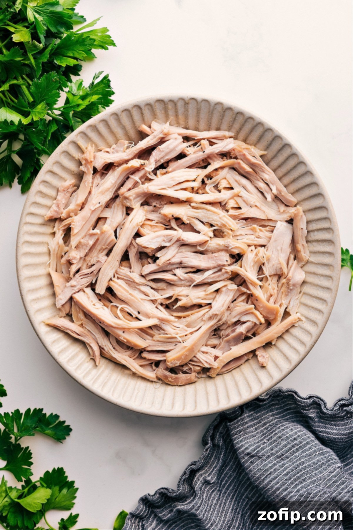 Perfectly shredded chicken in a bowl, ready to be used in various recipes.