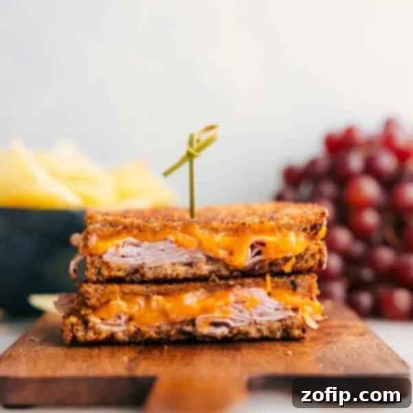 Ultimate Philly Cheesesteak Experience 5 The melty ham and cheese sandwich cut in half showing the delicious insides.