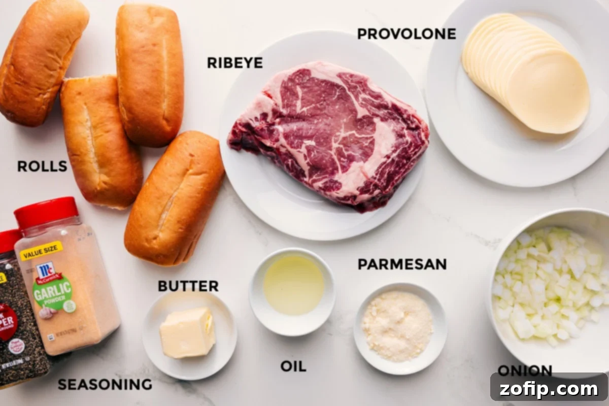 Ingredients In Philly Cheesesteak Recipe All the ingredients in this recipe prepped out for easy assembly including the rolls, seasonings, butter, oil, parmesan, ribeye, provolone, and onions.