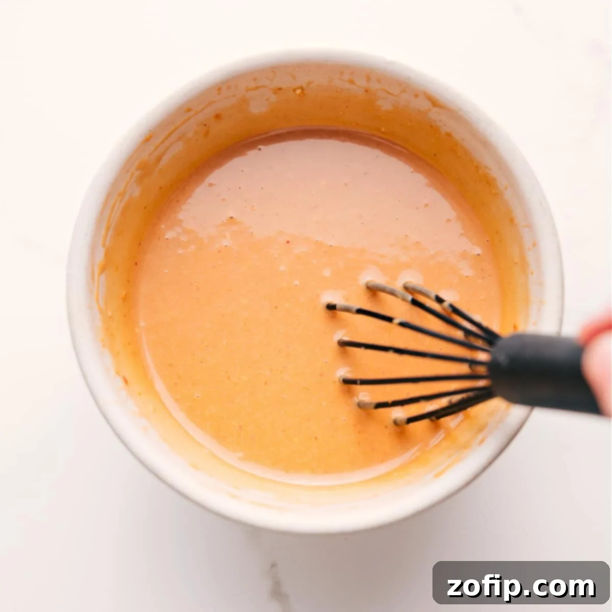 The simple dressing ingredients whisked together in a bowl.