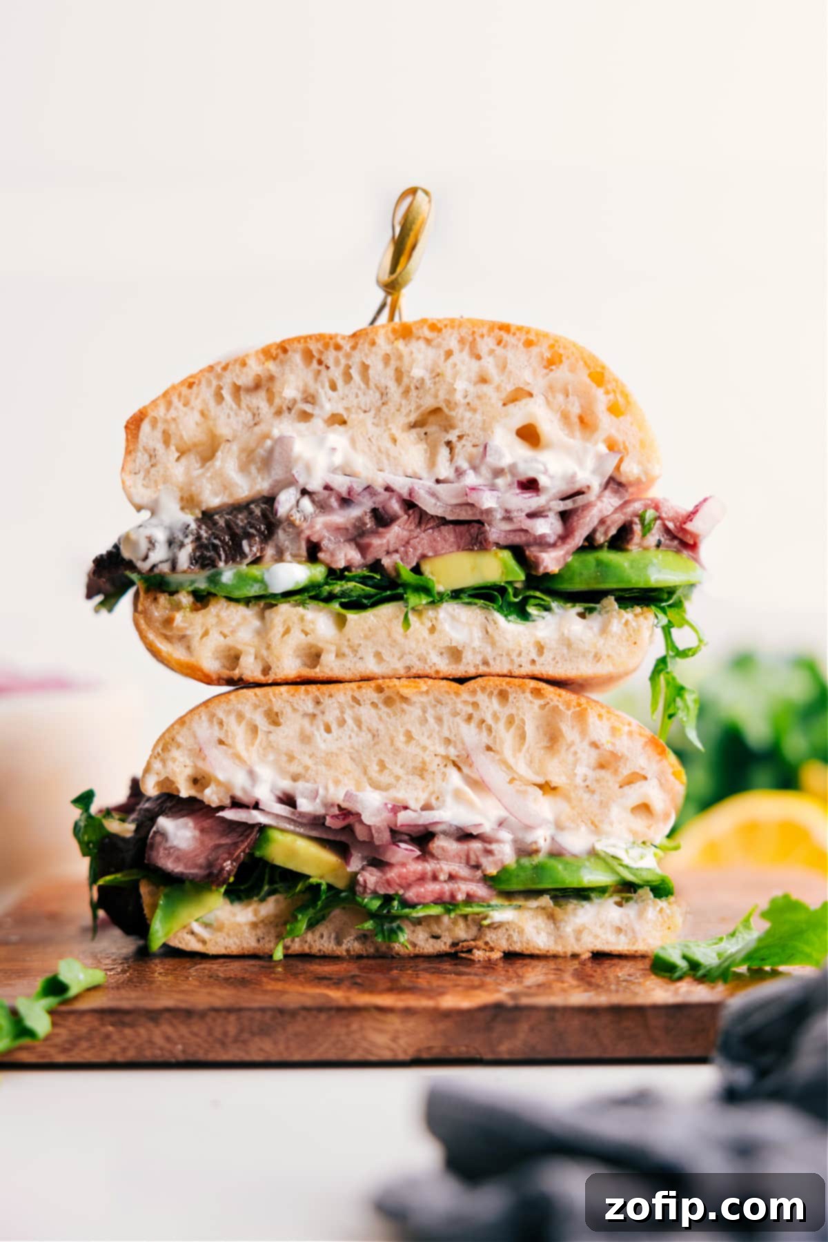 Stacked Steak Sandwiches with avocado, arugula, and aioli sauce
